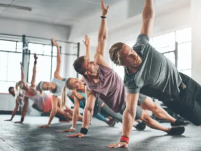Group doing squats with an ISSA trainer leading the class